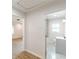 Hallway view into updated bathroom and additional room with wood-look flooring at 2806 Hedgewood Nw Dr, Atlanta, GA 30311