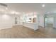 Open floor plan kitchen with island, white cabinetry, stainless appliances, and wood flooring at 2806 Hedgewood Nw Dr, Atlanta, GA 30311