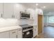 Kitchen with stainless steel microwave and electric oven, quartz countertops, and white subway tile backsplash at 2806 Hedgewood Nw Dr, Atlanta, GA 30311