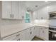 Gorgeous kitchen featuring quartz countertops, white subway tile backsplash, and stainless steel appliances at 2806 Hedgewood Nw Dr, Atlanta, GA 30311