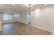 Open living room featuring wood-look floors, neutral paint, a ceiling fan and several windows at 2806 Hedgewood Nw Dr, Atlanta, GA 30311