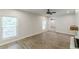 Open living room with wood-look floors, natural light, and a decorative fireplace at 2806 Hedgewood Nw Dr, Atlanta, GA 30311