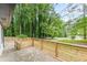 View of outdoor patio with wooden fence and lots of surrounding trees at 2806 Hedgewood Nw Dr, Atlanta, GA 30311