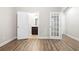 Spacious bedroom with wood-look floors, white trim, and open doors to ensuite bathroom and closet at 3657 Atherton Park Ct, Suwanee, GA 30024
