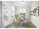 Cozy breakfast nook features a modern table set, beautiful decor, and a bright window at 3657 Atherton Park Ct, Suwanee, GA 30024
