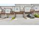 Exterior of townhomes featuring private garages and decks with a black truck parked in driveway at 3657 Atherton Park Ct, Suwanee, GA 30024