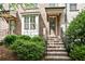 Inviting brick townhouse with a covered entrance and manicured landscaping at 3657 Atherton Park Ct, Suwanee, GA 30024
