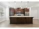 Stylish kitchen with a large center island and dark wood cabinetry at 3657 Atherton Park Ct, Suwanee, GA 30024
