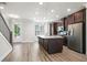 Modern kitchen with stainless steel appliances and a large island at 3657 Atherton Park Ct, Suwanee, GA 30024