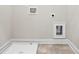 Laundry room with washer hookups, wood-look floors, neutral walls, and white trim at 3657 Atherton Park Ct, Suwanee, GA 30024
