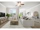 Comfortable living room showcases an elegant sofa, wooden accents, and a view to the outdoors at 3657 Atherton Park Ct, Suwanee, GA 30024
