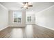 This living room boasts hardwood floors, large windows with blinds, and recessed lighting for ambiance at 3657 Atherton Park Ct, Suwanee, GA 30024