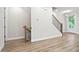 Bright, open living area with modern staircase and durable wood-look floors at 3657 Atherton Park Ct, Suwanee, GA 30024