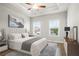 This main bedroom features a tray ceiling, a ceiling fan, and plush neutral accents at 3657 Atherton Park Ct, Suwanee, GA 30024