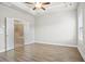 Large main bedroom includes a ceiling fan and an open door into the elegant ensuite bathroom at 3657 Atherton Park Ct, Suwanee, GA 30024