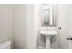 This half bath showcases pedestal sink with chrome fixtures and a neutral color palette at 3657 Atherton Park Ct, Suwanee, GA 30024