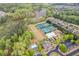 Overhead view of the community, featuring a pool, tennis courts, a lake, and wooded areas at 610 Syemore Pass, Canton, GA 30115