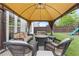 Backyard features a covered patio with comfortable seating, perfect for relaxing and entertaining guests outdoors at 610 Syemore Pass, Canton, GA 30115