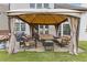 Backyard features a covered patio with comfortable seating, perfect for relaxing and entertaining guests outdoors at 610 Syemore Pass, Canton, GA 30115