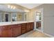 Bright bathroom featuring double sink vanity, tile flooring, and generous mirror at 610 Syemore Pass, Canton, GA 30115