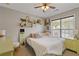 Cozy bedroom featuring stylish decor, a ceiling fan, and a sunlit window at 610 Syemore Pass, Canton, GA 30115