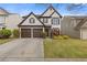 Charming two-story home features a well-manicured lawn and a two-car garage at 610 Syemore Pass, Canton, GA 30115