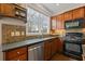 Traditional style kitchen with wood cabinets, granite countertops, stainless steel appliances, and a large window at 610 Syemore Pass, Canton, GA 30115