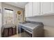 Well-lit laundry room featuring front load machines, white cabinets, and a convenient laundry hamper at 610 Syemore Pass, Canton, GA 30115