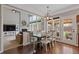 Open-concept living area with large windows, cozy seating, hardwood floors, and neutral paint colors at 610 Syemore Pass, Canton, GA 30115
