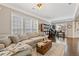 Inviting living room featuring hardwood floors, comfortable sofa, and bright lighting at 610 Syemore Pass, Canton, GA 30115
