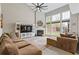 Spacious living room featuring large windows and a fireplace, perfect for Gathering gatherings or cozy evenings at 610 Syemore Pass, Canton, GA 30115
