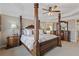 Luxurious main bedroom with tray ceiling, four-poster bed, and ensuite bathroom at 610 Syemore Pass, Canton, GA 30115