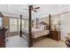 Spacious main bedroom featuring tray ceiling, a four-poster bed, and natural light at 610 Syemore Pass, Canton, GA 30115