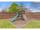 Backyard view of playground with slide, swing, and climbing features surrounded by a wood chip area at 610 Syemore Pass, Canton, GA 30115