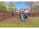 Backyard view of playground with slide, swing, and climbing features surrounded by a wood chip area at 610 Syemore Pass, Canton, GA 30115