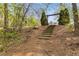 Stone steps leading up a grassy hill towards the house at 610 Syemore Pass, Canton, GA 30115