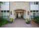 Elegant condominium entrance with brick pathway, stone archway, and lush landscaping at 625 Piedmont Ne Ave # 3029, Atlanta, GA 30308