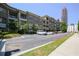Condominium complex featuring brick and stone accents with the city skyline in the distance at 625 Piedmont Ne Ave # 3029, Atlanta, GA 30308