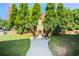 An inviting stone fireplace with two chairs nestled among lush evergreen trees for cozy outdoor gatherings at 625 Piedmont Ne Ave # 3029, Atlanta, GA 30308