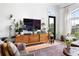 Stylish living room featuring a TV, plants, and hardwood floors at 625 Piedmont Ne Ave # 3029, Atlanta, GA 30308