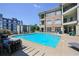 Refreshing community pool with comfortable lounge seating, waterfall feature, and scenic views at 625 Piedmont Ne Ave # 3029, Atlanta, GA 30308