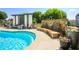 Relaxing poolside with a decorative waterfall, comfortable seating, and lush potted plants at 625 Piedmont Ne Ave # 3029, Atlanta, GA 30308
