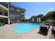 Inviting pool area with lounge chairs, waterfall feature, and nearby seating area at 625 Piedmont Ne Ave # 3029, Atlanta, GA 30308