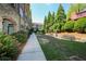 A walkway surrounded by flower beds and lush green common area offers a peaceful, inviting outdoor space at 625 Piedmont Ne Ave # 3029, Atlanta, GA 30308