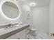 Modern powder room with a sleek vanity, stylish round mirror, and elegant fixtures at 2795 Peachtree Rd # 1305, Atlanta, GA 30305