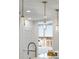 Modern kitchen lighting fixture with crystal pendants highlighting the gray countertops at 2795 Peachtree Rd # 1305, Atlanta, GA 30305