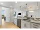 Modern kitchen with stainless steel appliances and marble countertops with an open concept to the living room at 2795 Peachtree Rd # 1305, Atlanta, GA 30305