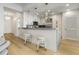 Bright kitchen with white cabinetry, stainless steel appliances, breakfast bar, and pendant lighting at 2795 Peachtree Rd # 1305, Atlanta, GA 30305