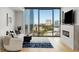 Living room with floor-to-ceiling windows, modern furnishings, sleek fireplace and city views at 2795 Peachtree Rd # 1305, Atlanta, GA 30305