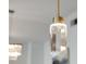Contemporary crystal pendant light with brushed brass hardware in modern dining room at 2795 Peachtree Rd # 1305, Atlanta, GA 30305
